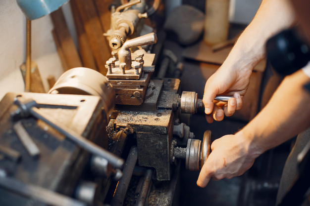 handsome-carpenter-working-with-wood_1157-26117